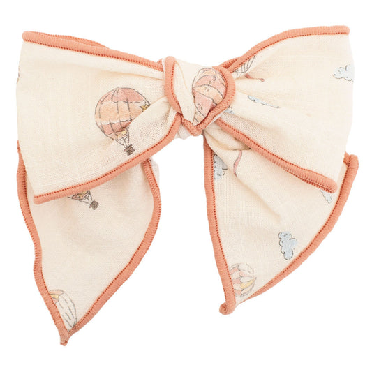 bow hairclip with hot air balloon design on a white background