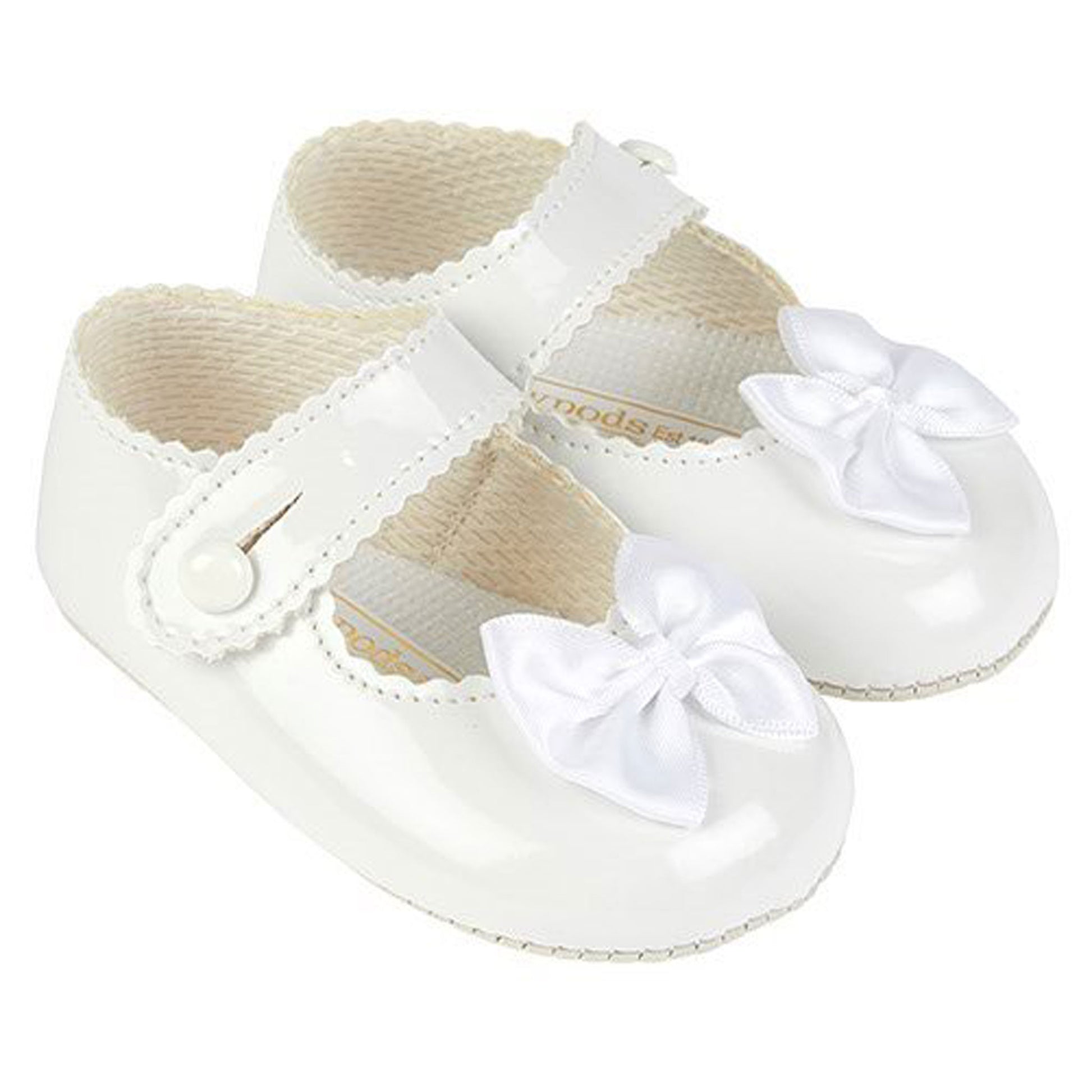 White baby shoes with bows on a white background