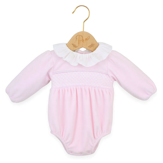 Pink baby romper with white collar on a wooden hanger against a white background