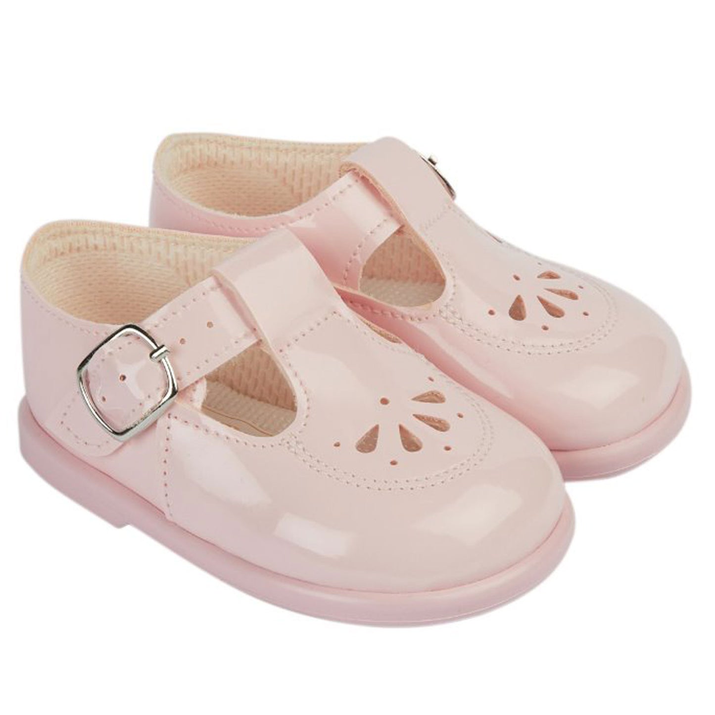 Pair of pink children's shoes with a buckle on a white background