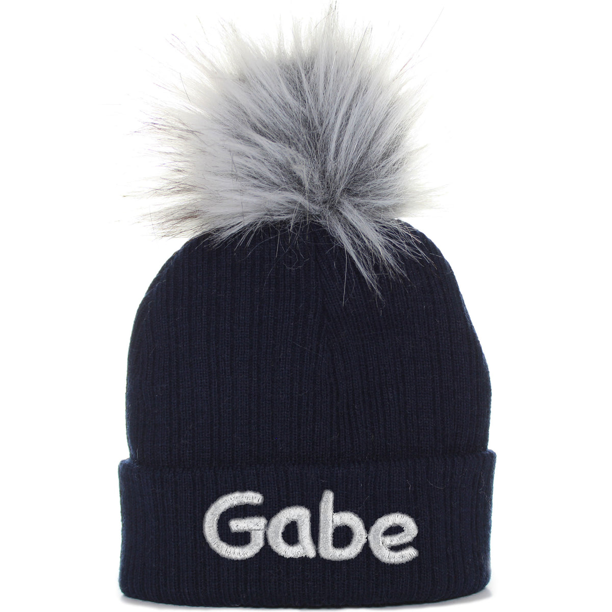 Navy blue baby hat with faux fur pom pom, featuring the name 'Gabe' in white letters on the cuff.
