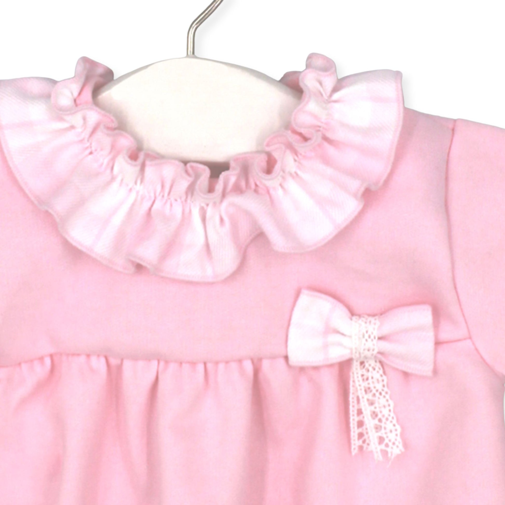 Pink baby dress with ruffled collar and bow on a white background