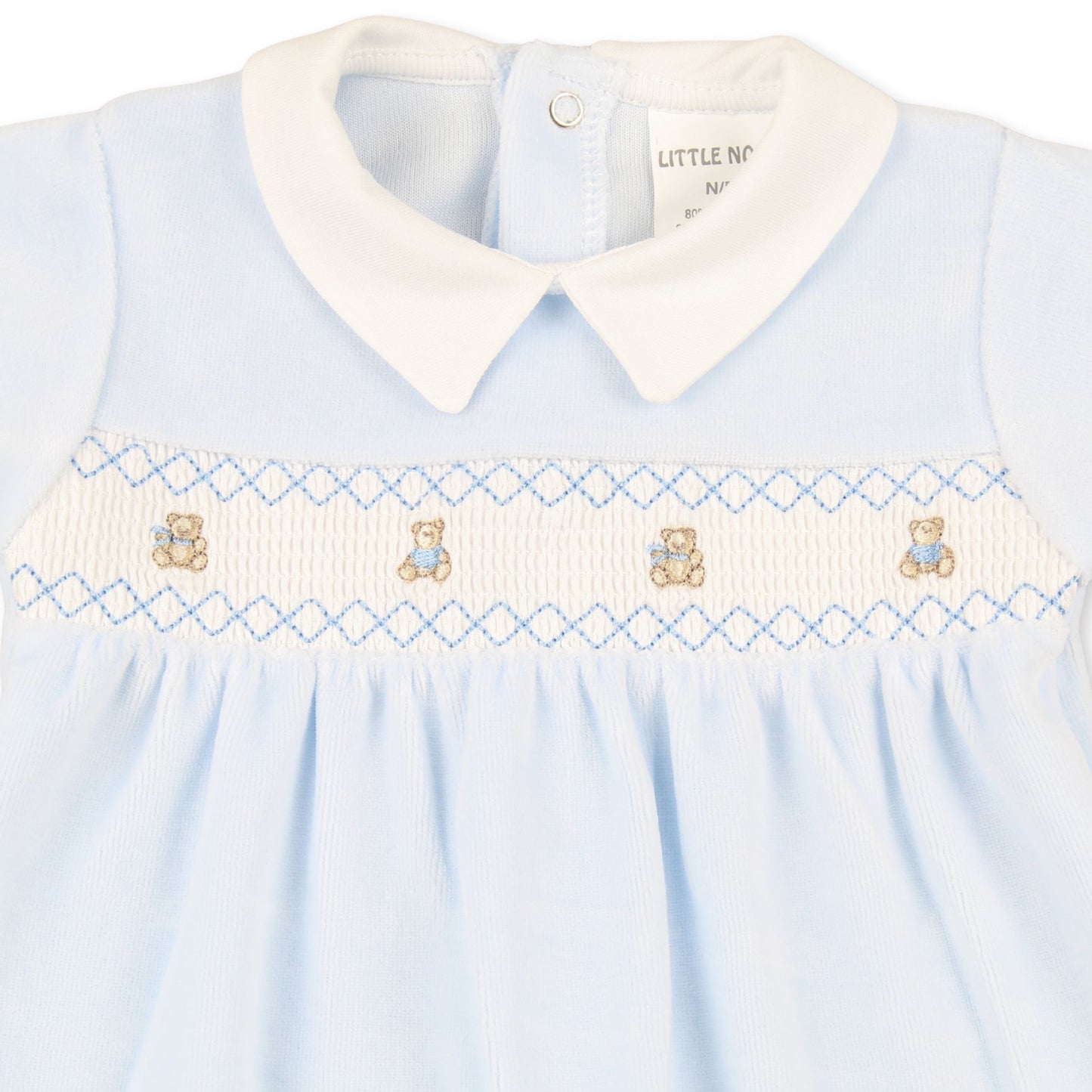 Light blue baby dress with white collar and teddy bear embroidery on a white background