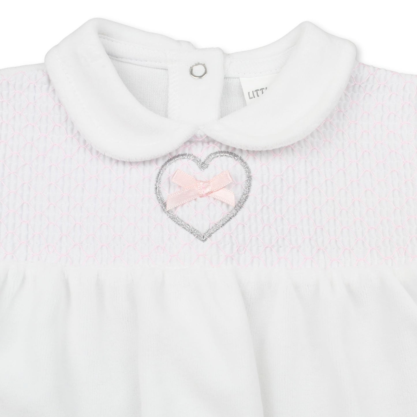 White baby outfit with a heart-shaped pink bow and collar on a white background
