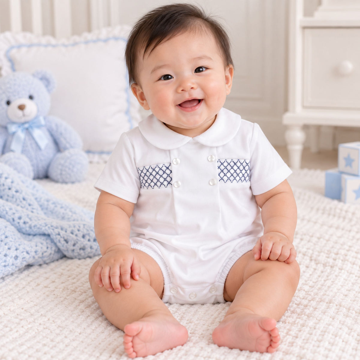 baby boys white romper with navy lattice smocking