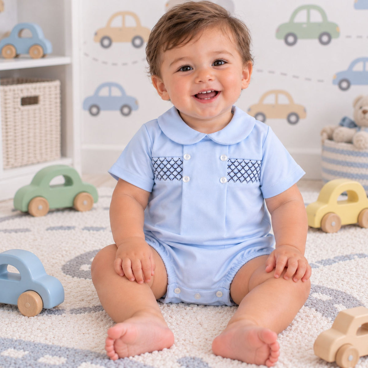blue romper with white buttons and navy lattice smocking
