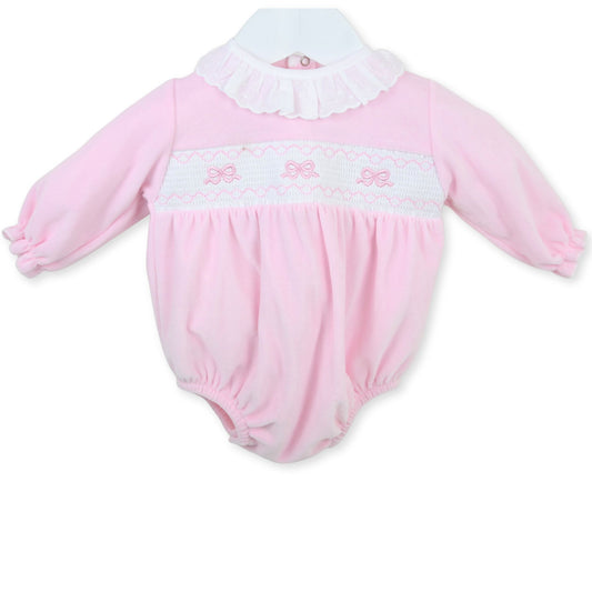 Pink baby romper with white collar and bow details
