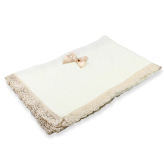 Cream shawl with beige lace trim and a decorative bow on a white background