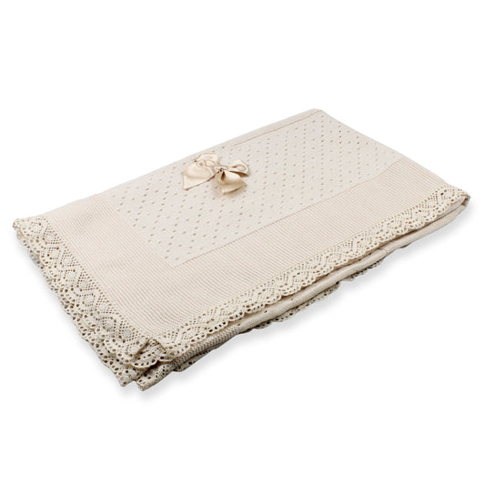 Beige lace blanket with a bow on a white background