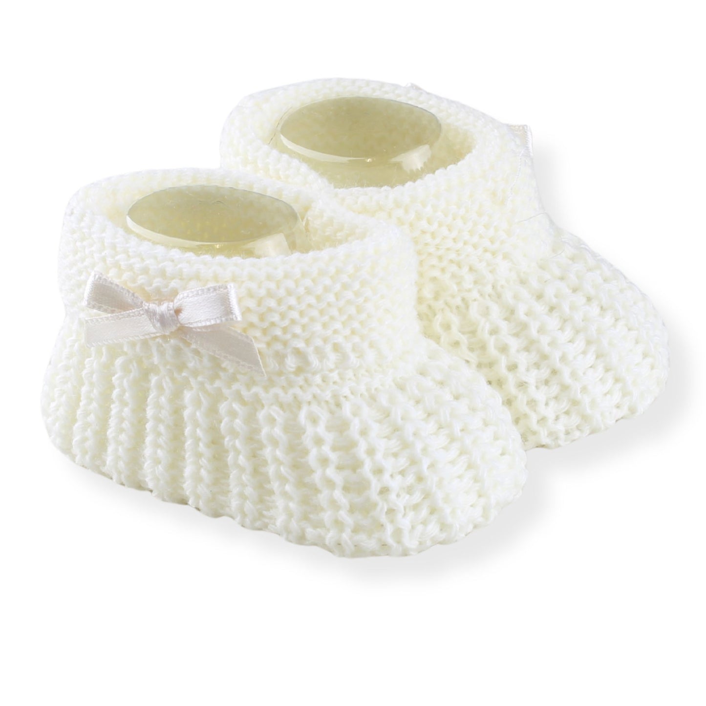 Cream knitted baby booties with a bow on a white background