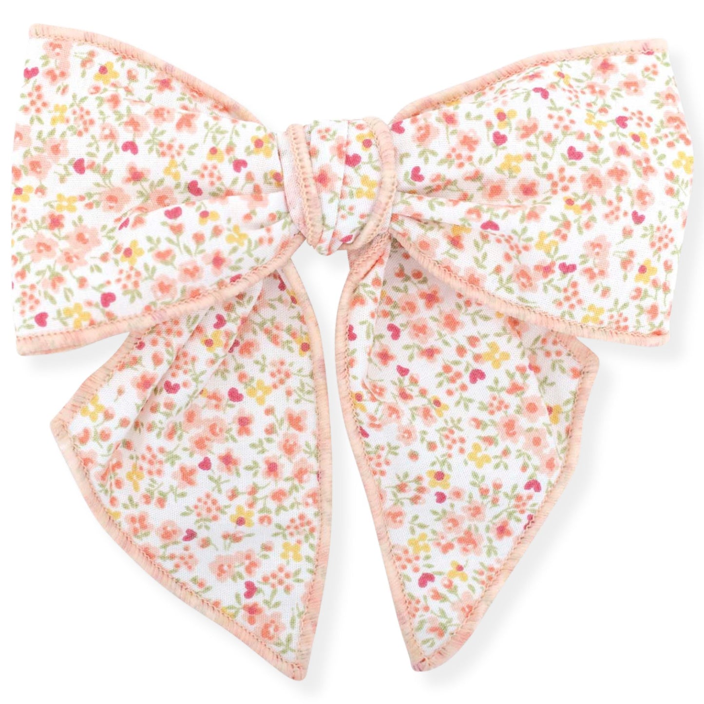 Floral patterned bow with pink accents on a white background