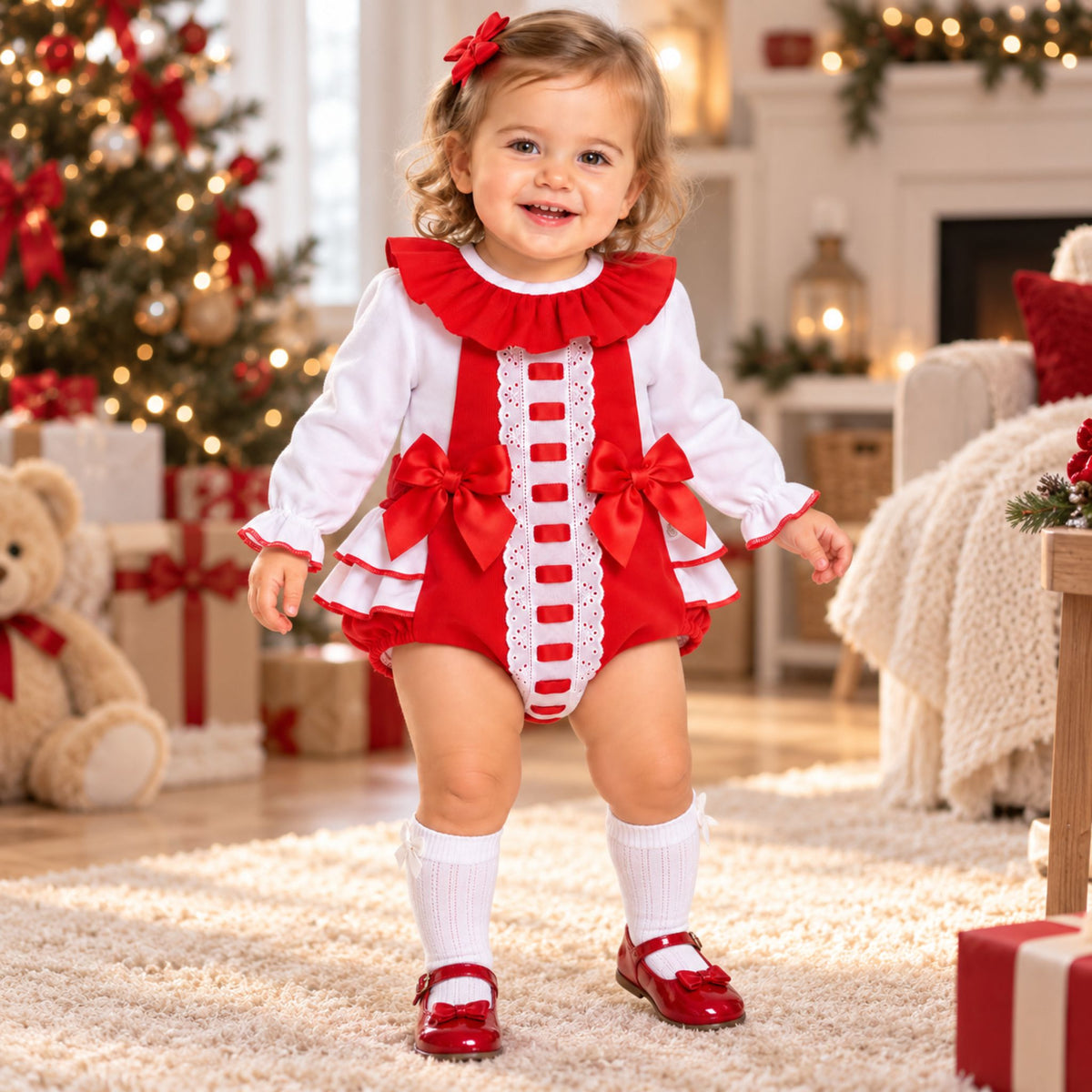 Baby girl wearing red frill romper and white blouse two piece outfit