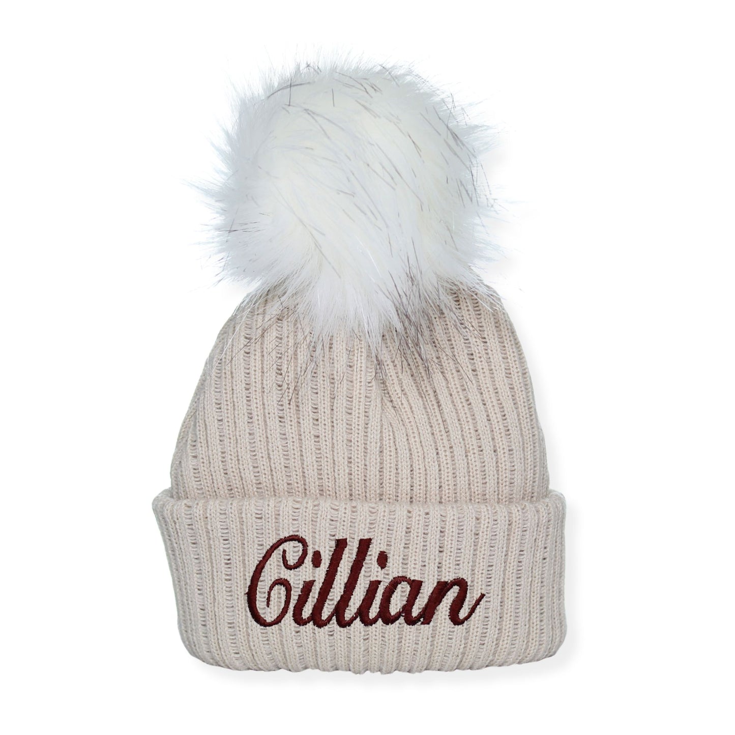 Beige knit beanie with white pom-pom and embroidered name 'Cillian' on a white background