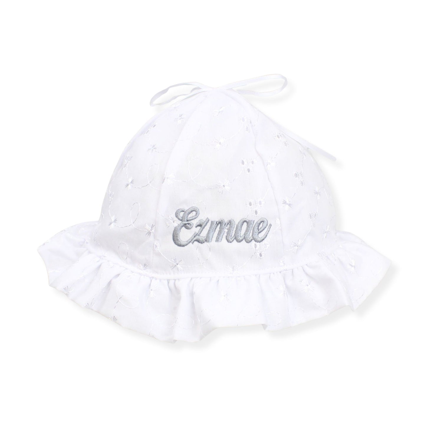 White baby hat with 'Ezmae' embroidery on a white background