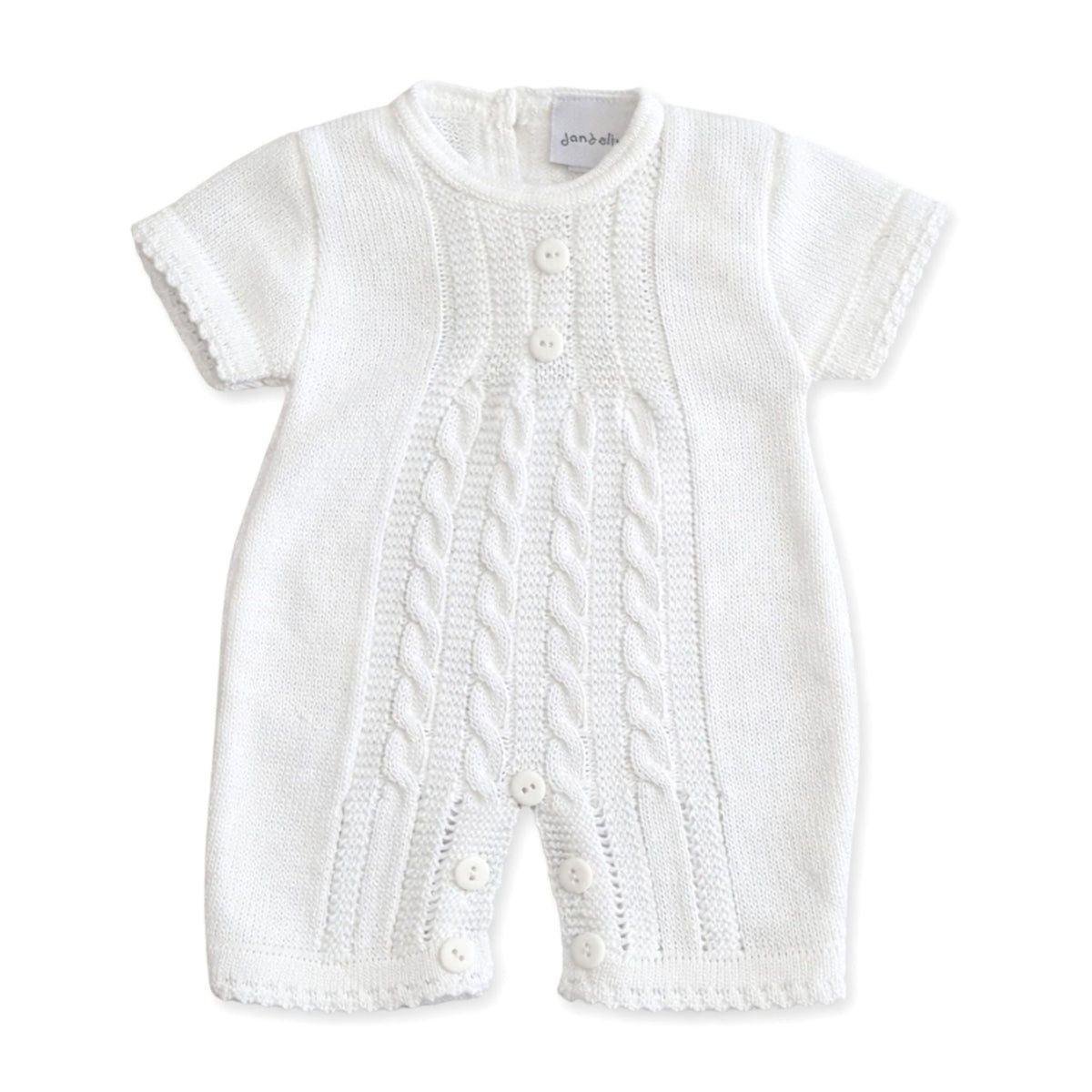 White knitted baby romper with cable pattern on a white background
