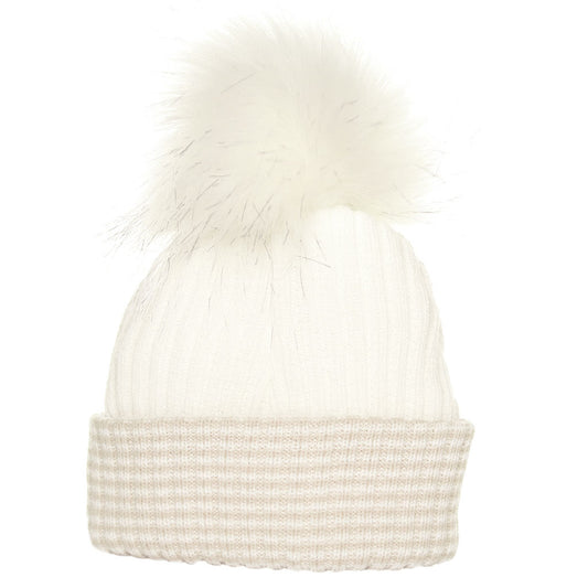 White knit beanie with pom-pom on a white background