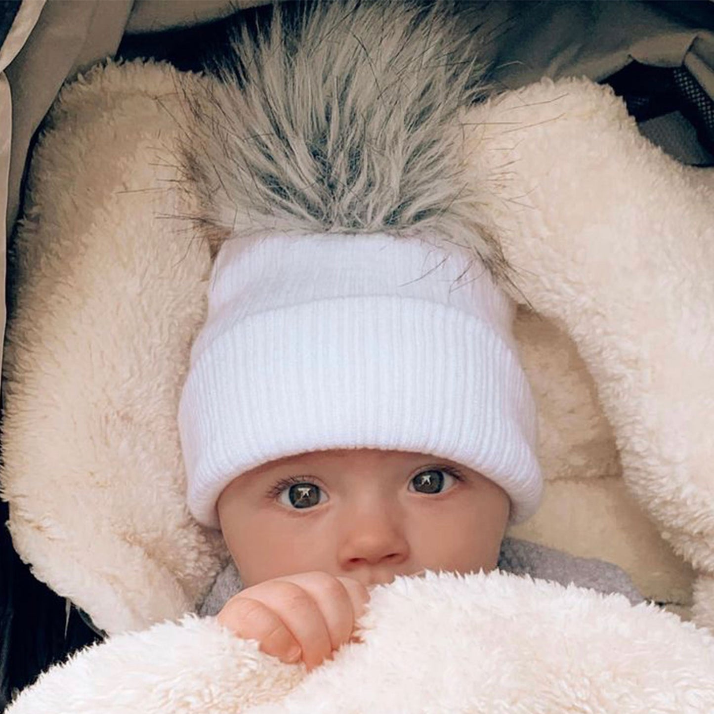 white baby hat knitted newborn pom