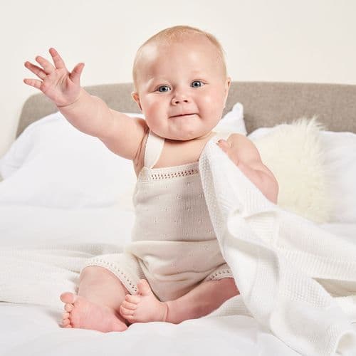 white knitted baby dungarees