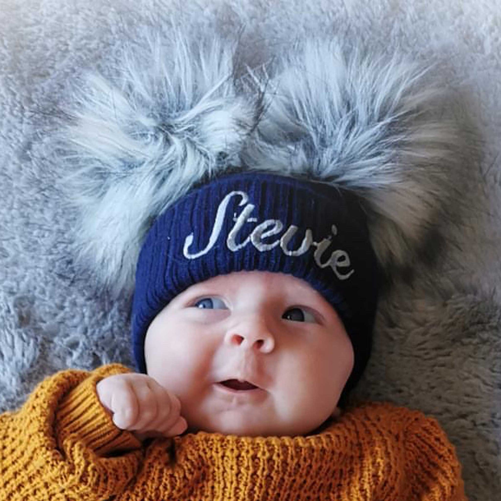 personalised baby hay navy with two pom poms