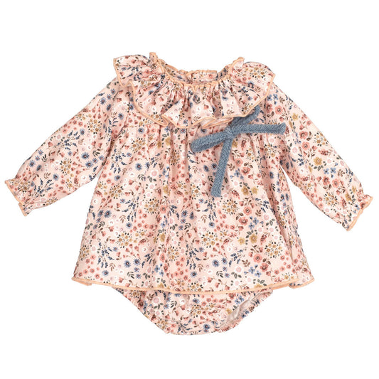 Floral baby romper with a bow on a white background