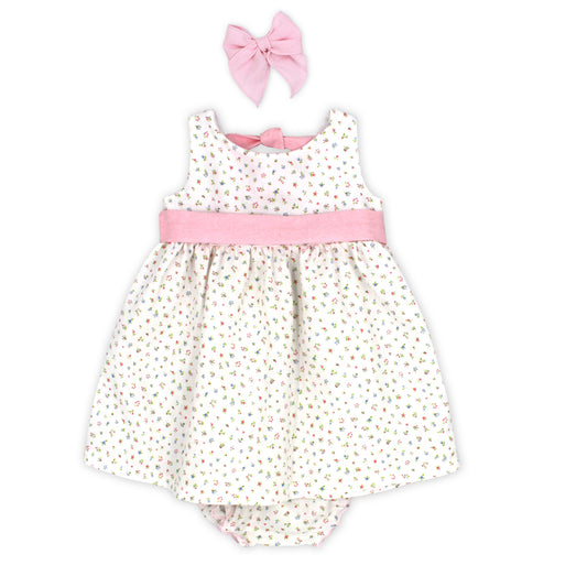 Baby romper with floral pattern and pink bow headband on a white background