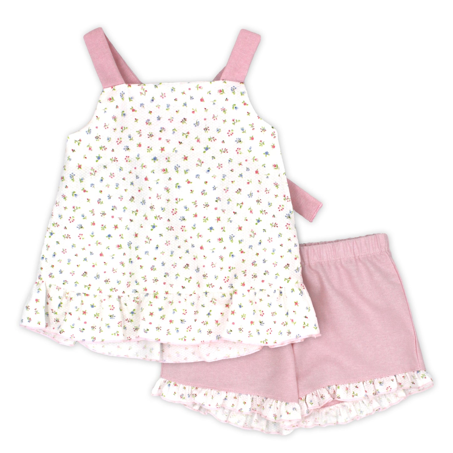 Children's outfit with floral dress and pink shorts on a white background