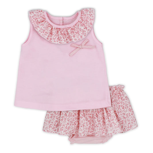 Pink children's outfit with floral details on a white background