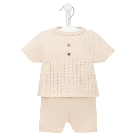 Beige textured top and shorts set on a hanger against a white background