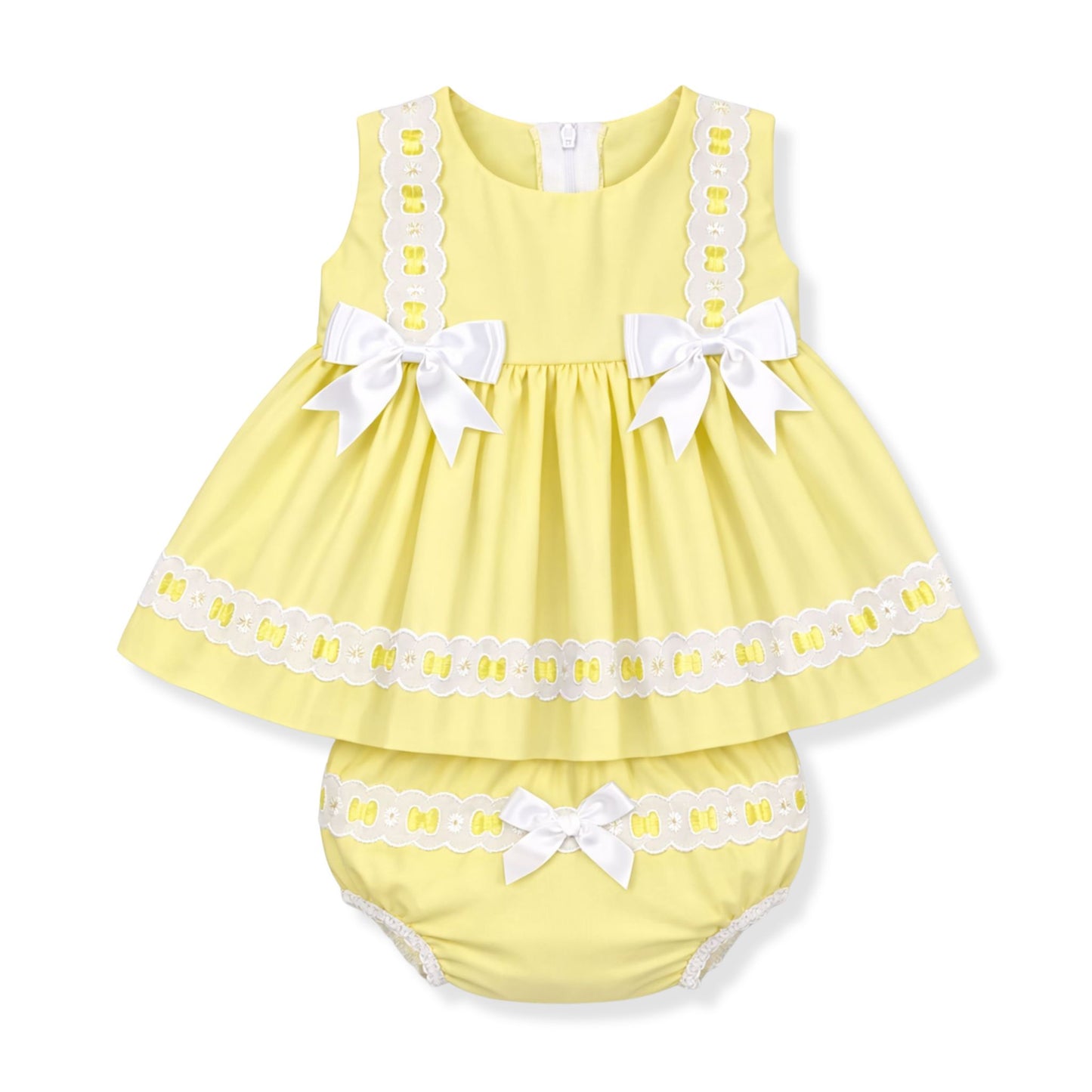 Yellow baby dress with white lace and bows on a white background