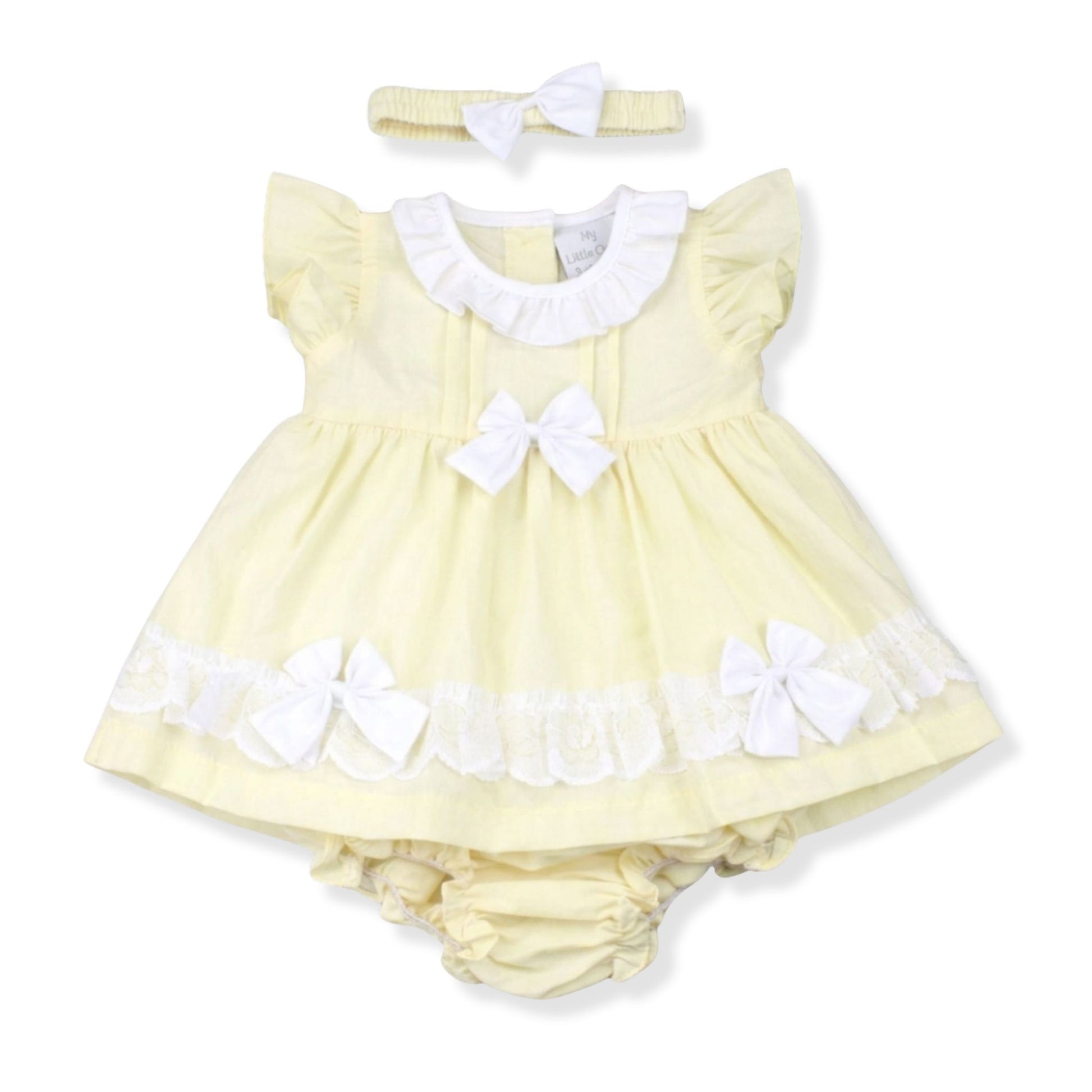Yellow baby dress with white details and matching headband on a white background