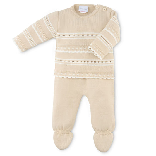 Beige baby outfit with lace details on a white background