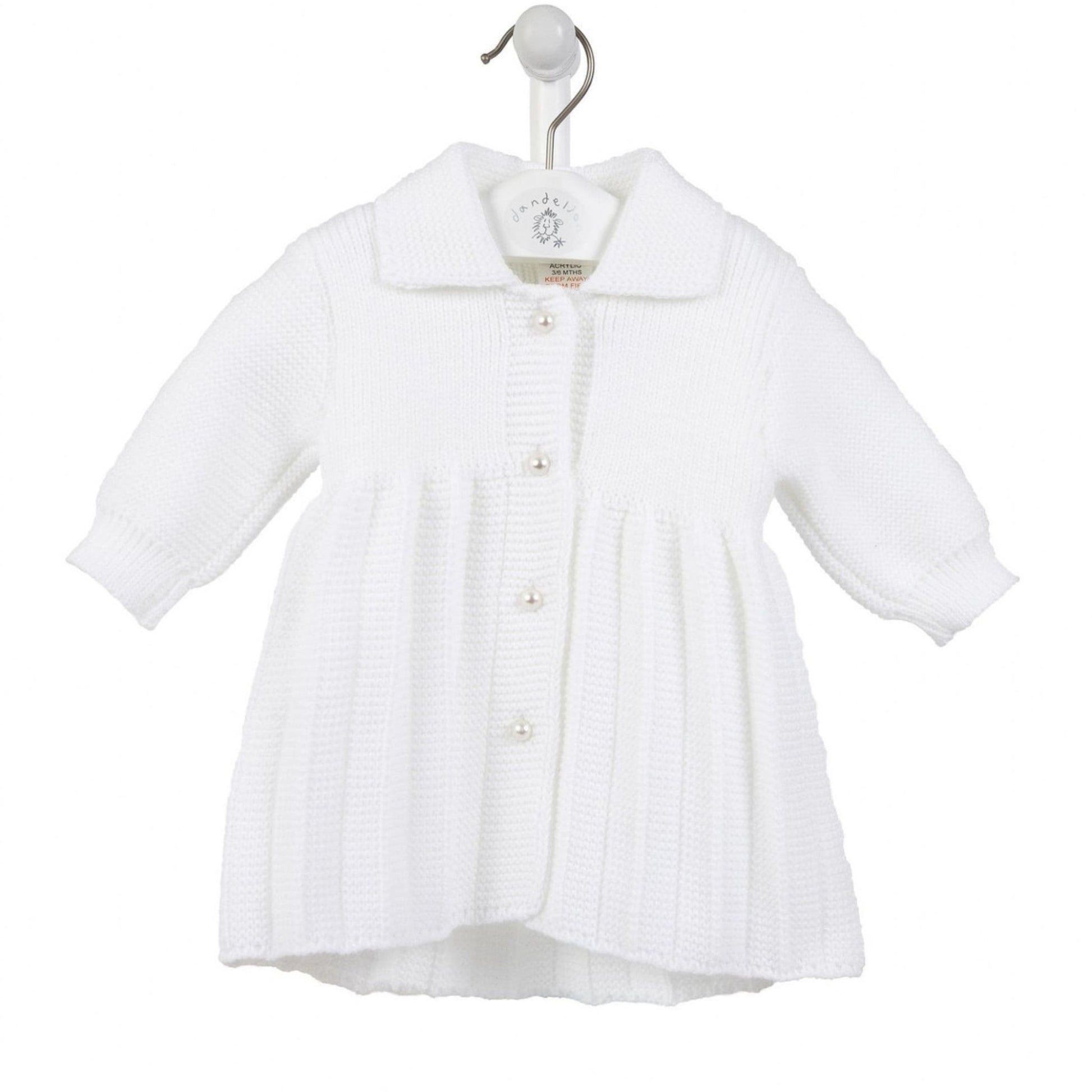 White baby coat on a hanger against a white background