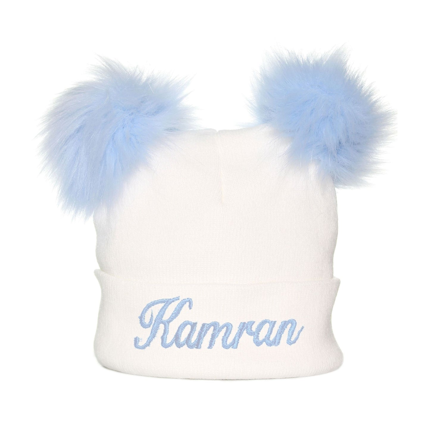White beanie with blue fur pom-poms and embroidered name 'Kamran' on a white background