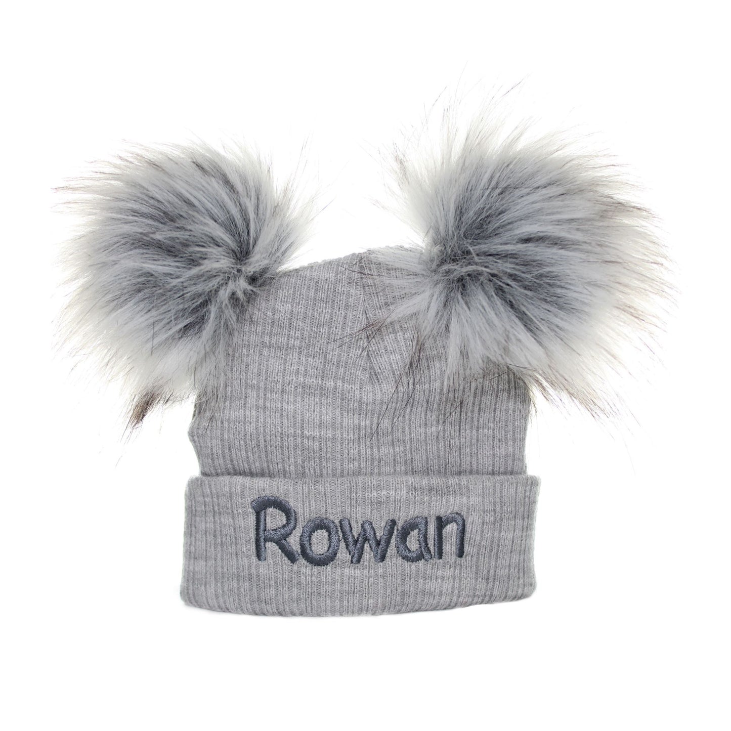 Gray knit hat with two large fur pom-poms and the name 'Rowan' embroidered on a white background
