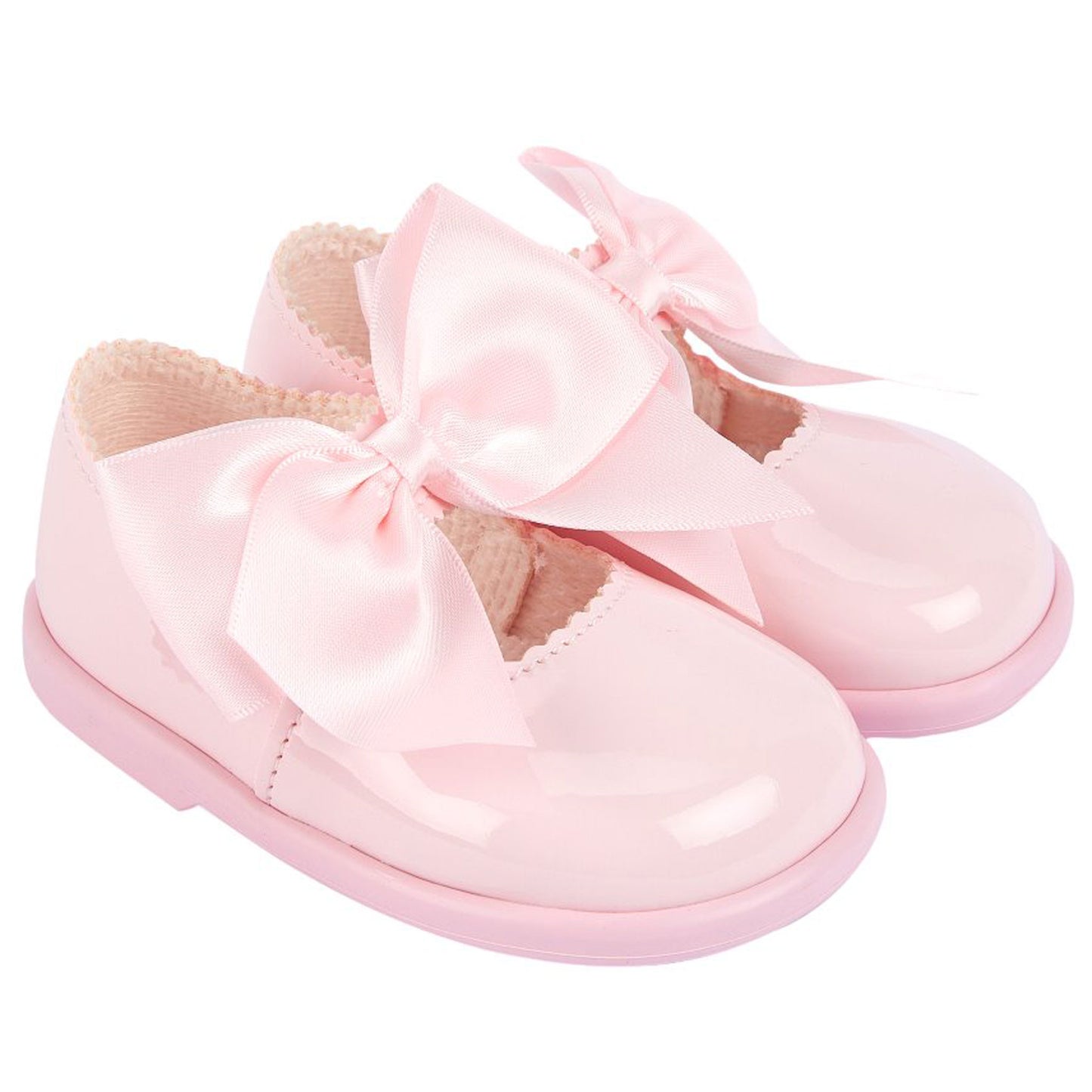 Pink baby shoes with a bow on a white background