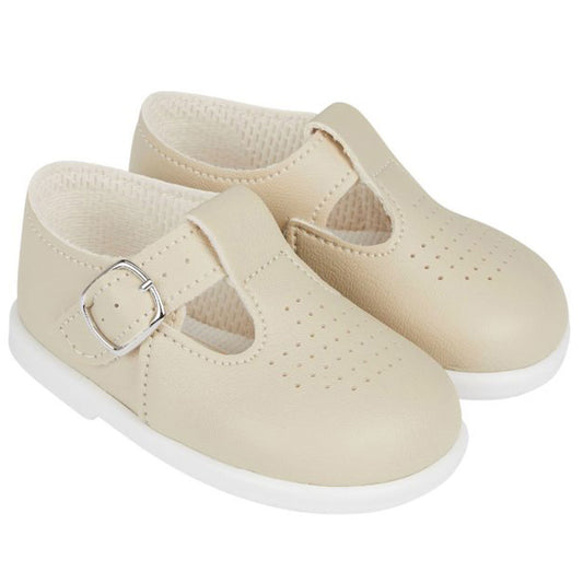 Beige children's shoes with a buckle on a white background