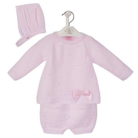 Pink baby romper with matching hat on a white background