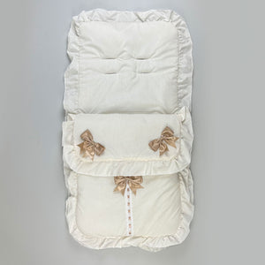 cream footmuff with three beige bows