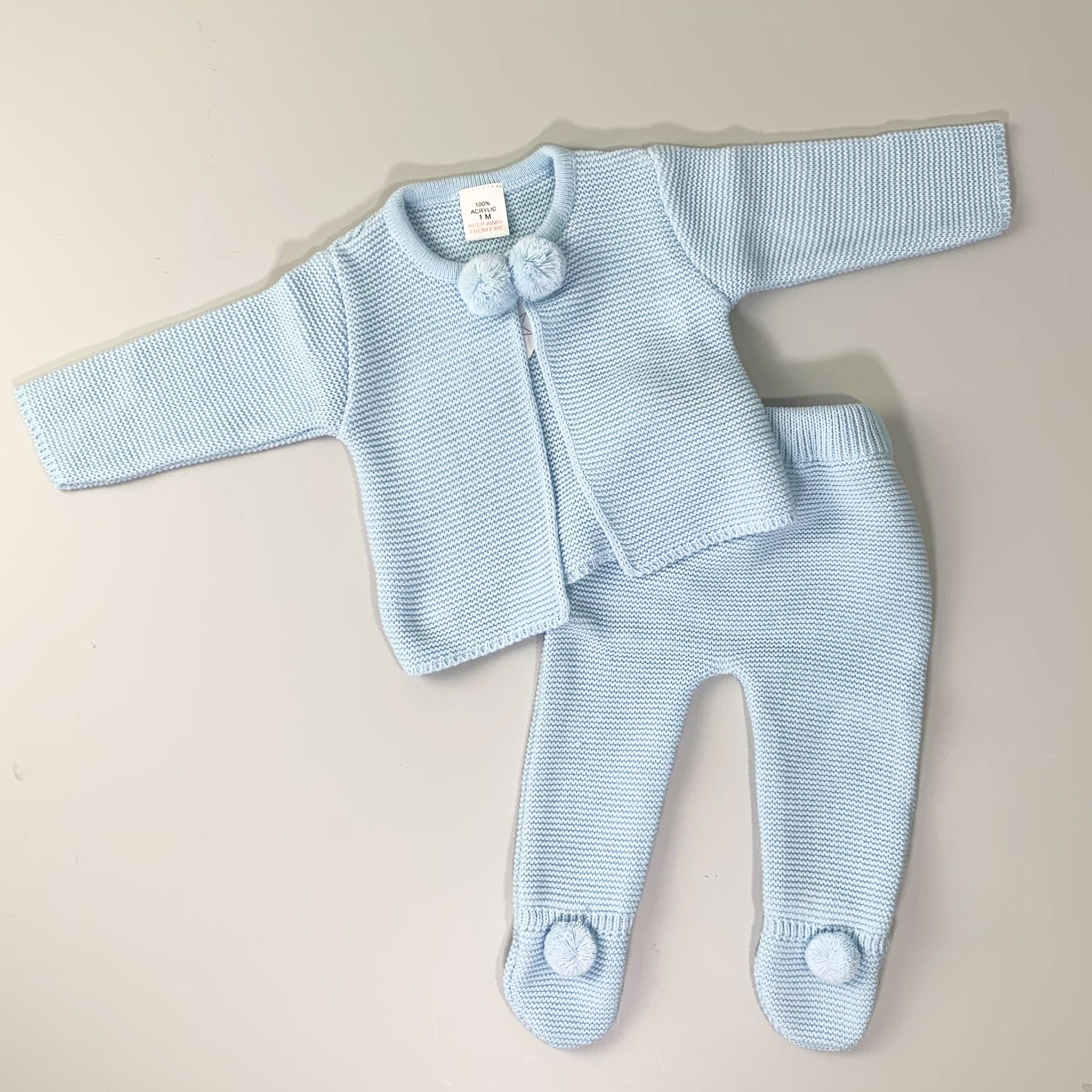 baby boy knitted outfit with pom poms in blue