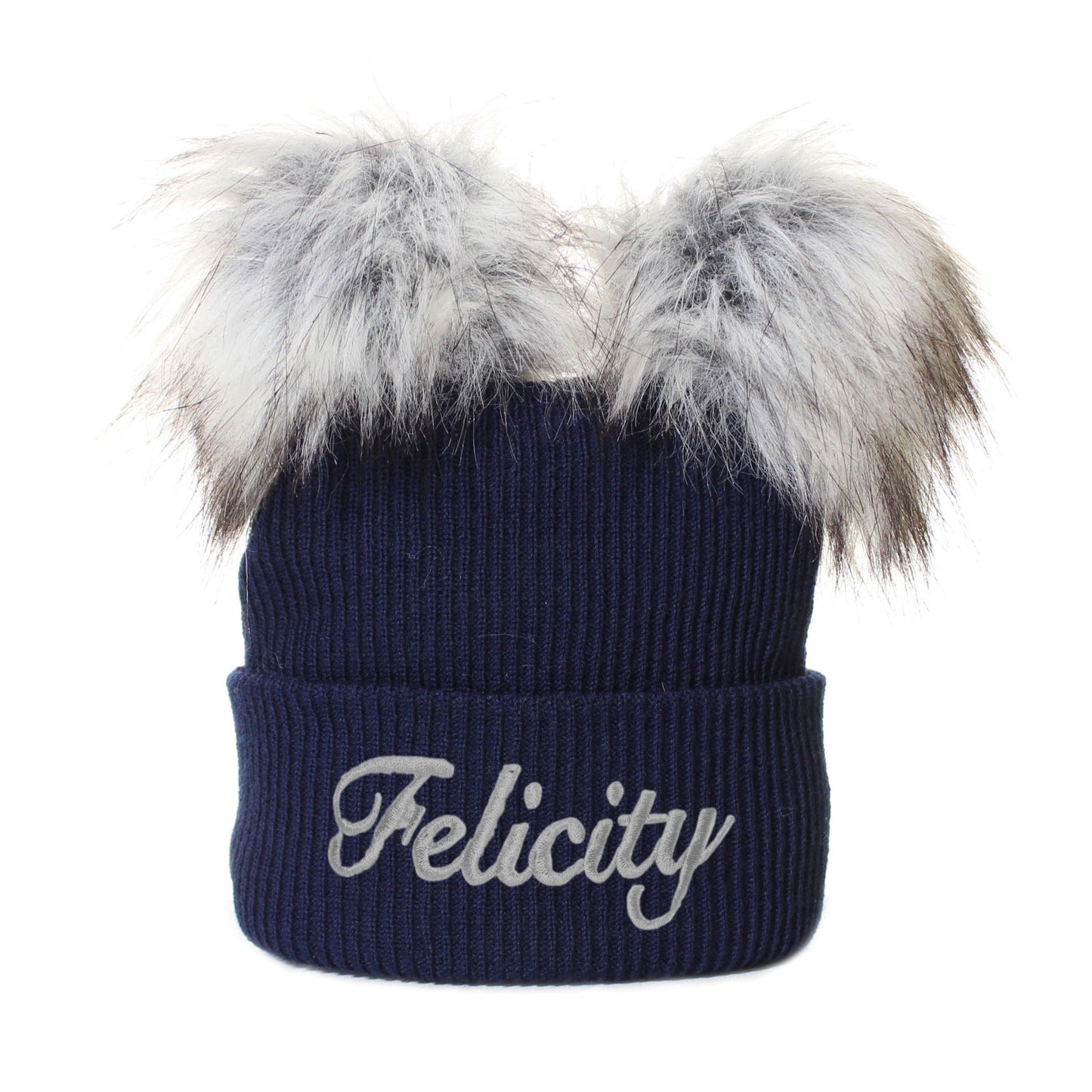 Navy blue beanie with faux fur pom-poms and 'Felicity' embroidery on a white background
