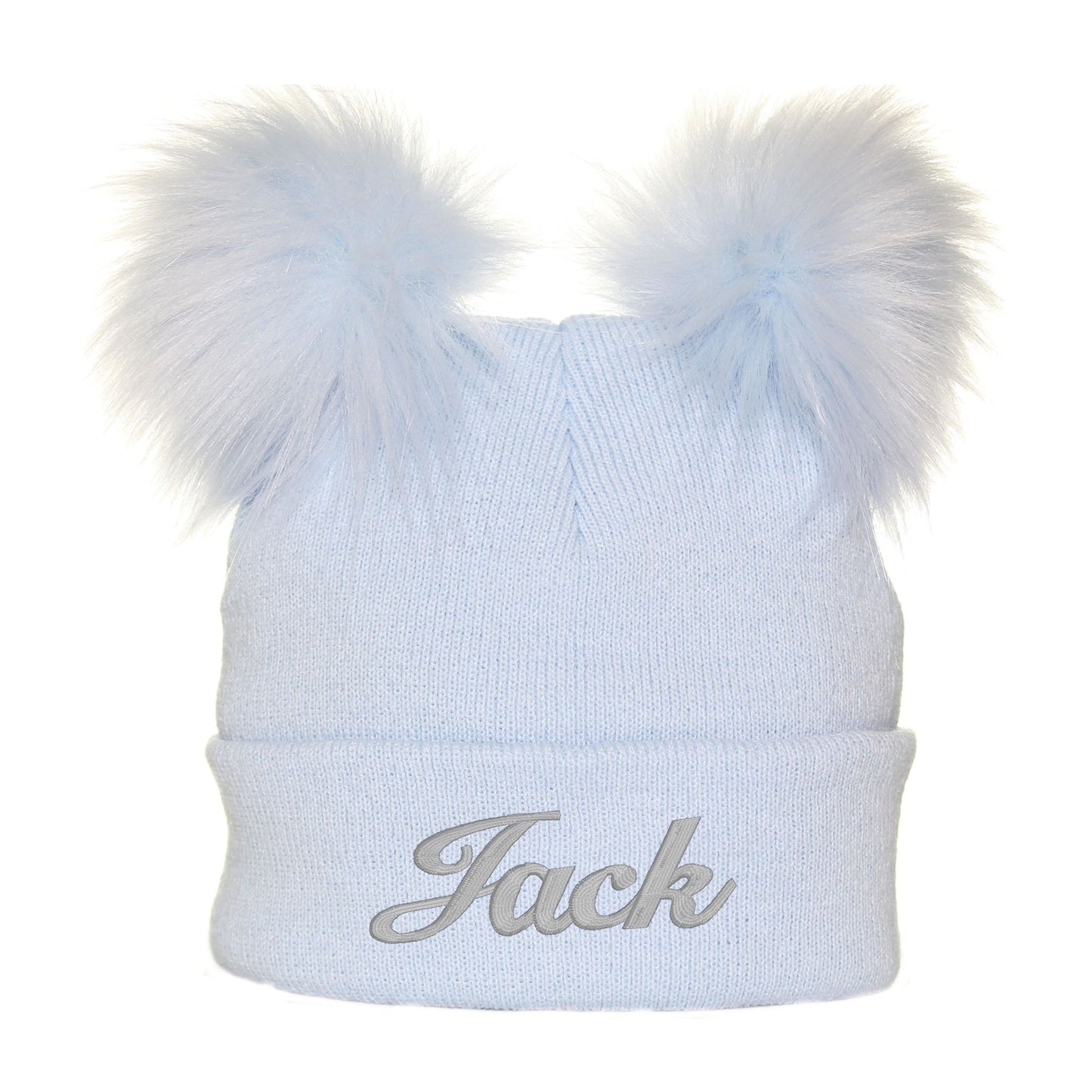 Light blue knit beanie with two white fur pom-poms and 'Jack' embroidery on a white background