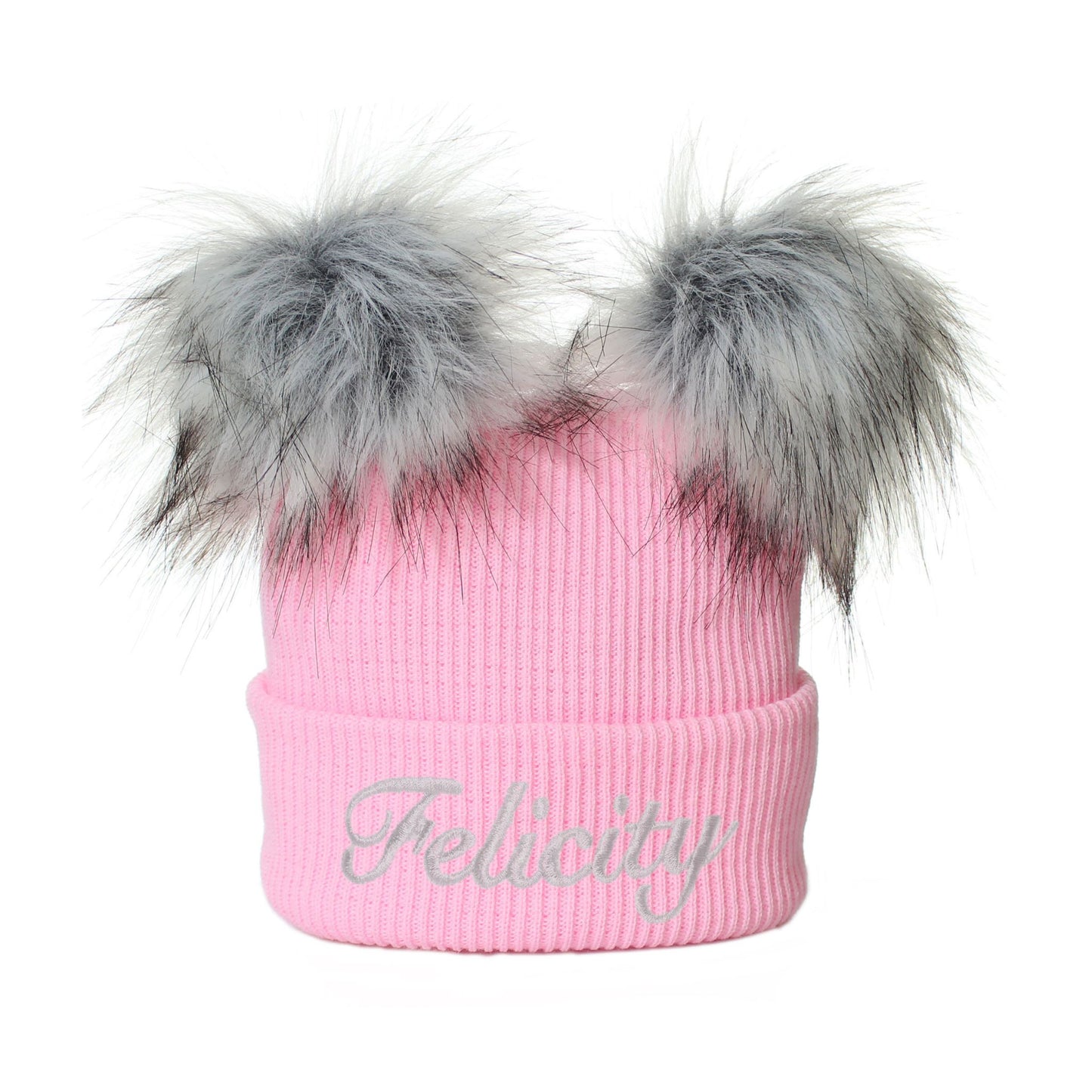 Pink beanie with gray fur pom-poms and 'Felicity' embroidery on a white background