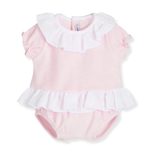 Pink baby romper with white ruffled collar and hem on a white background