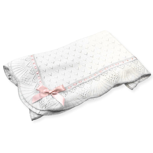White baby blanket with pink bow on a white background