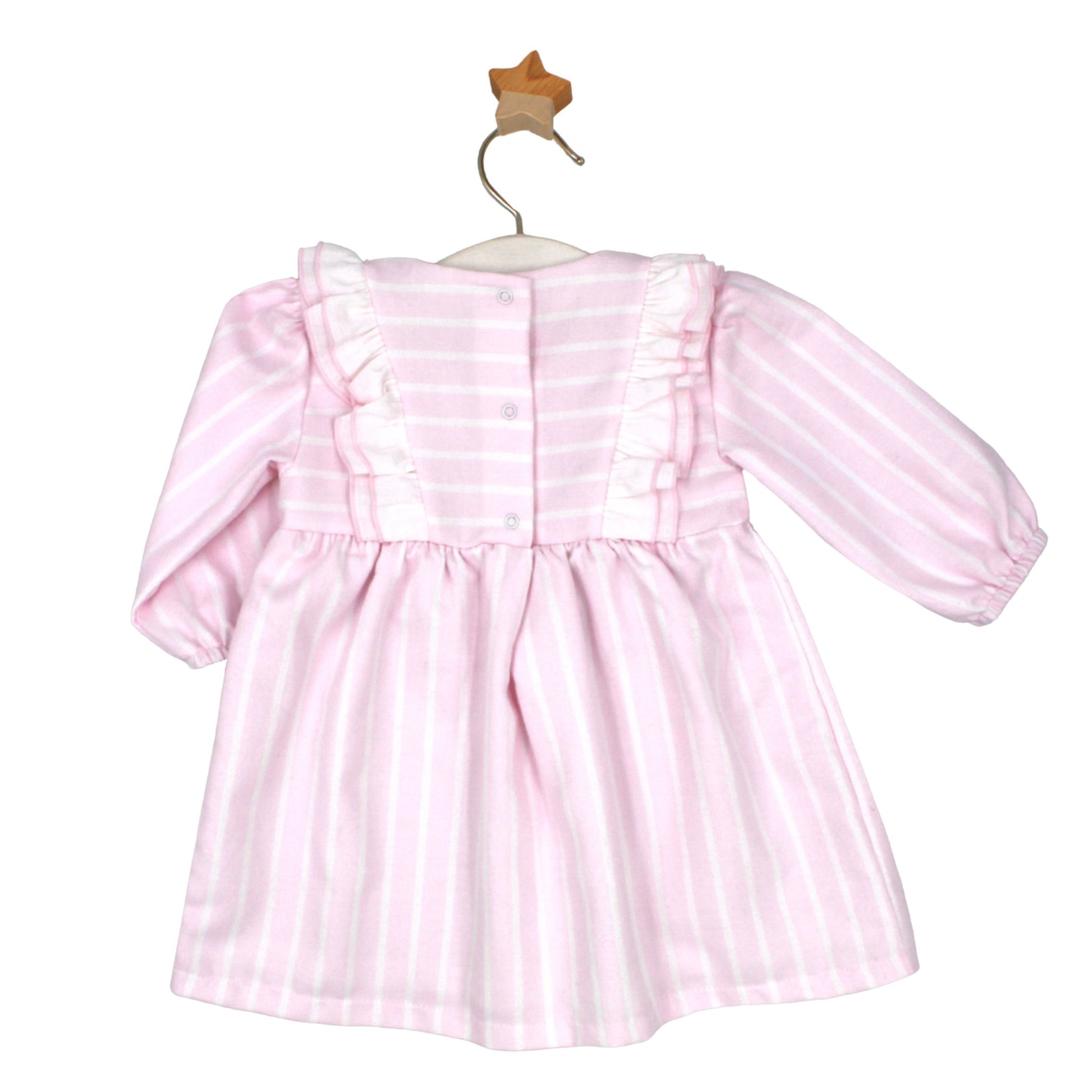 Pink and white striped baby dress with frill detail and bib-style front, displayed on a white hanger with a wooden star hook.


