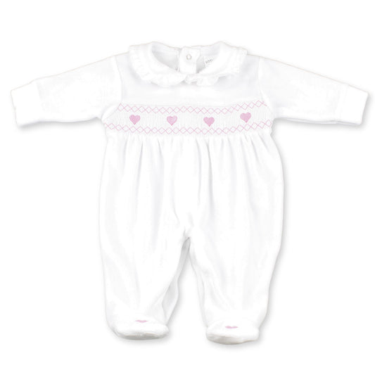 White baby romper with pink heart patterns on a white background