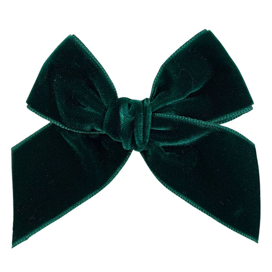 Green velvet bow on a white background