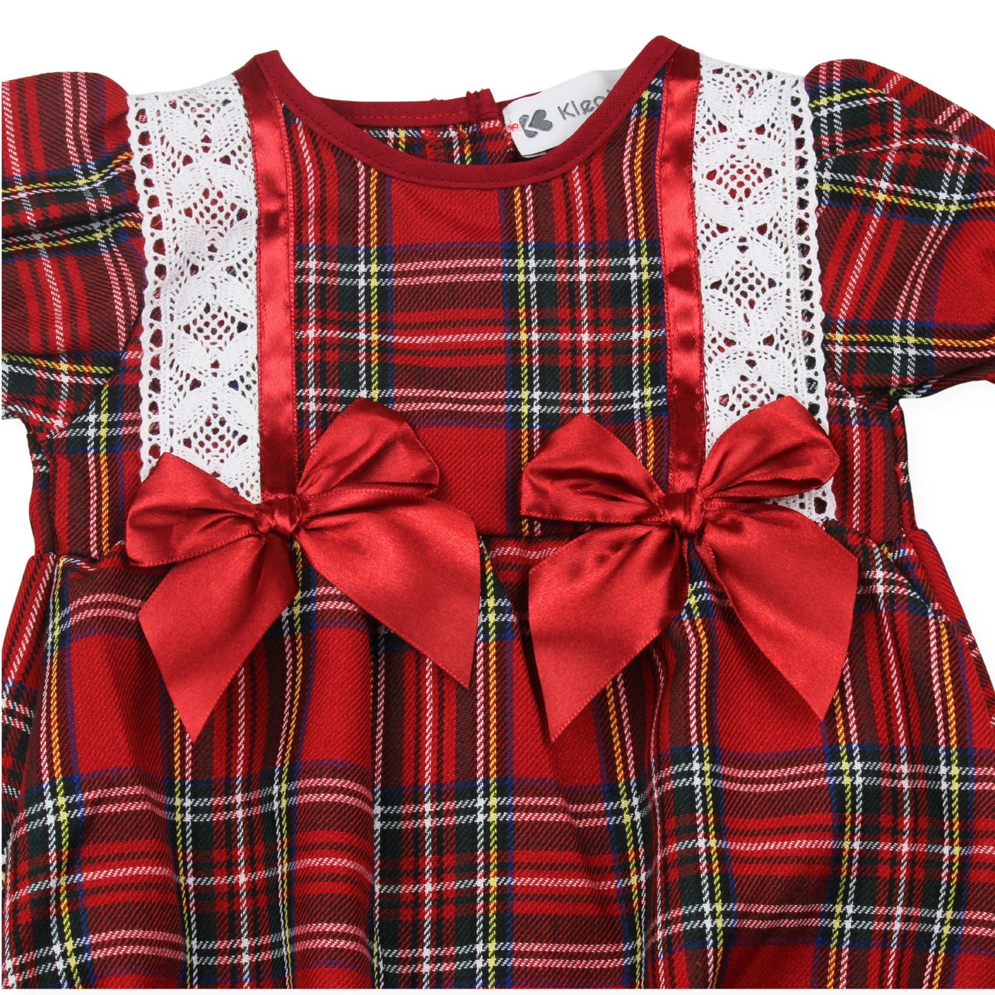 Red plaid dress with lace details and large bows on a white background