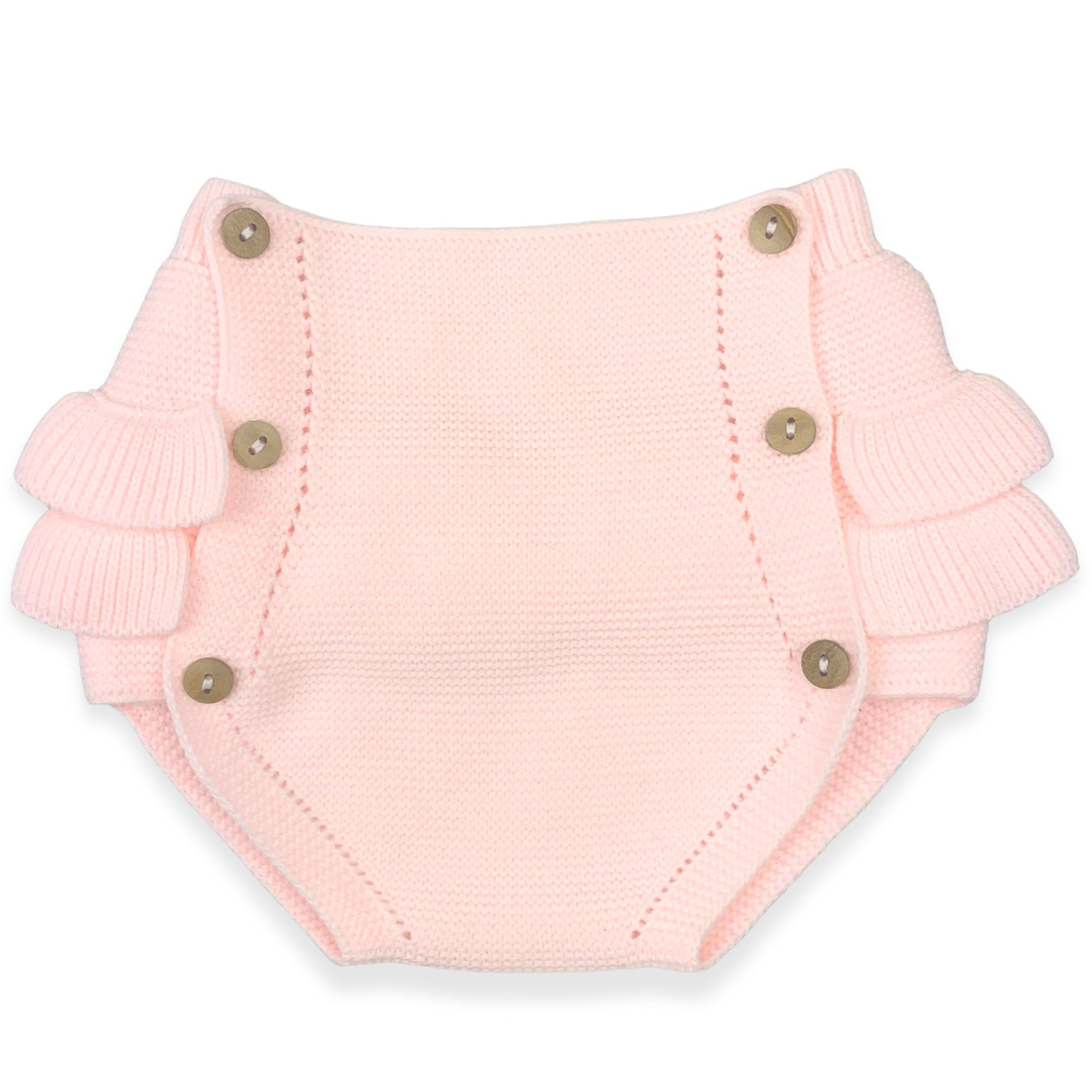 Pink knitted pants with buttons on a white background