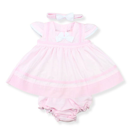 Pink baby dress with white trim and matching headband on a white background